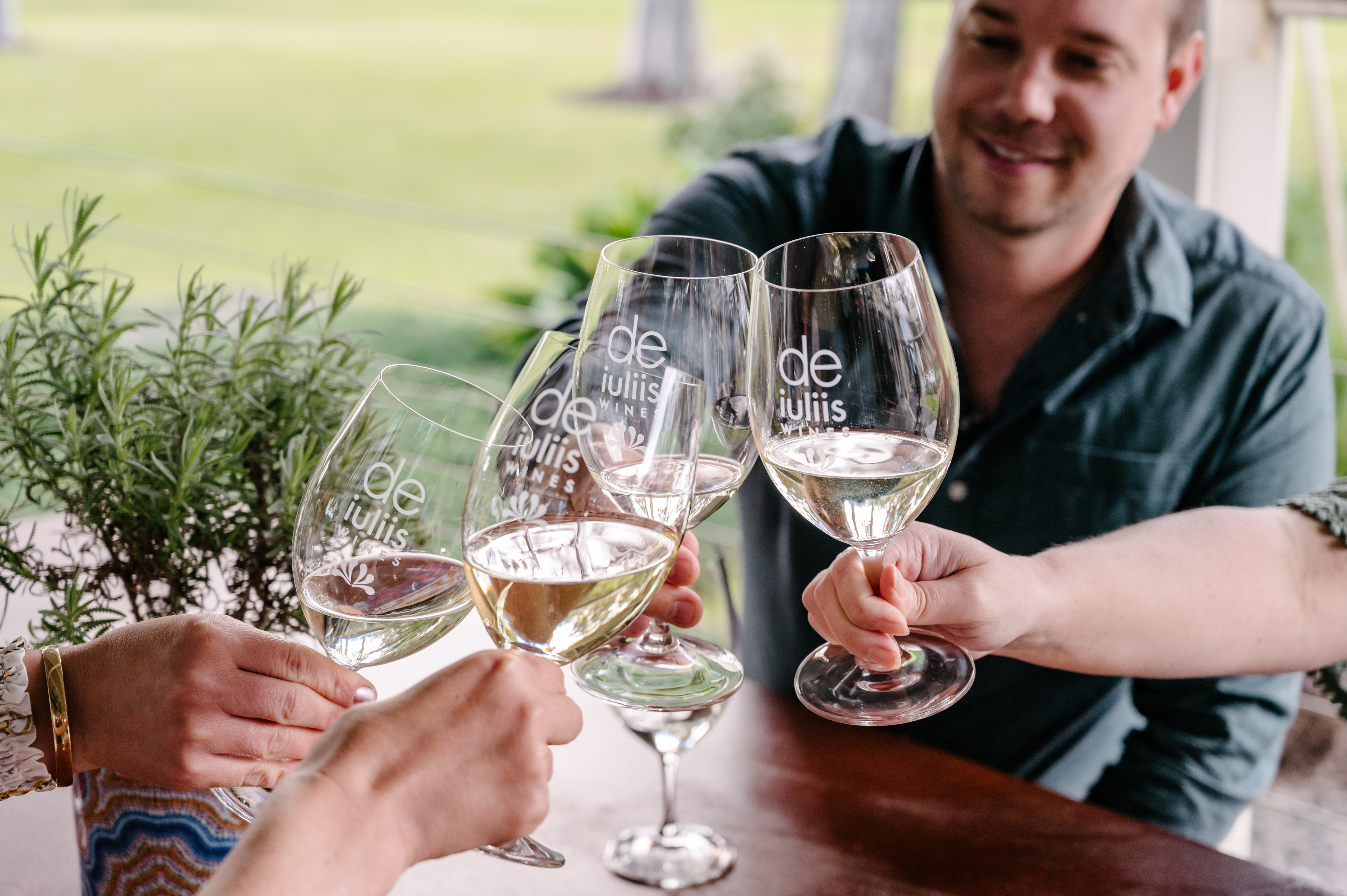 People toasting with De Iuliis wineglasses 